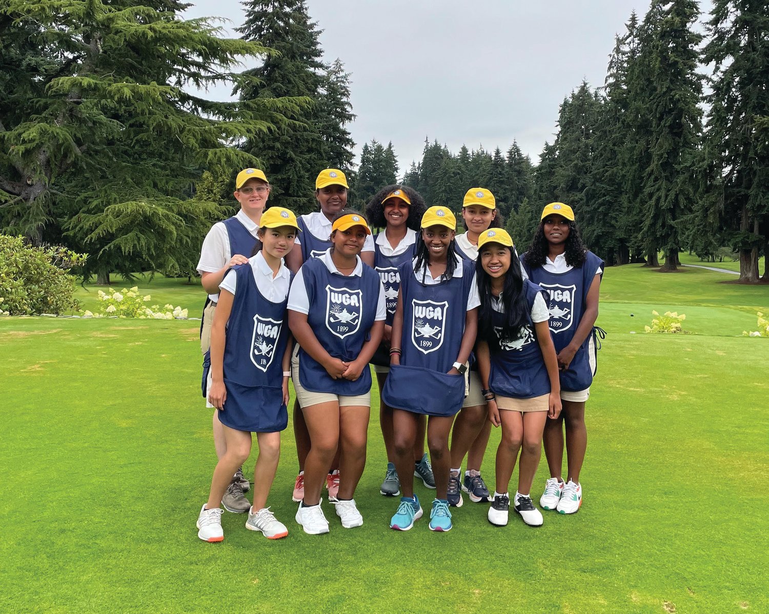 Tadu Dollarhide (center) and eight young women from the Seattle area joined the caddie academy for its second annual program at the Seattle and Broadmoor golf clubs.